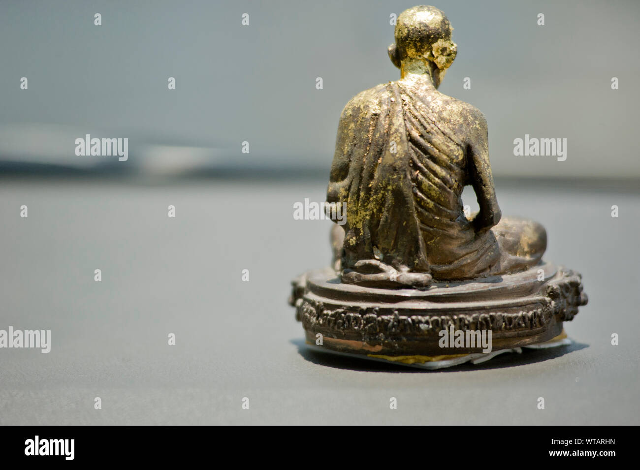 Mini statue of a monk inside a taxi car Stock Photo