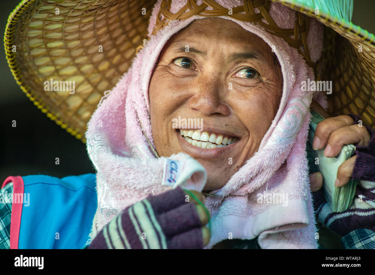 Street market worker wearing traditional oriental hat Stock Photo