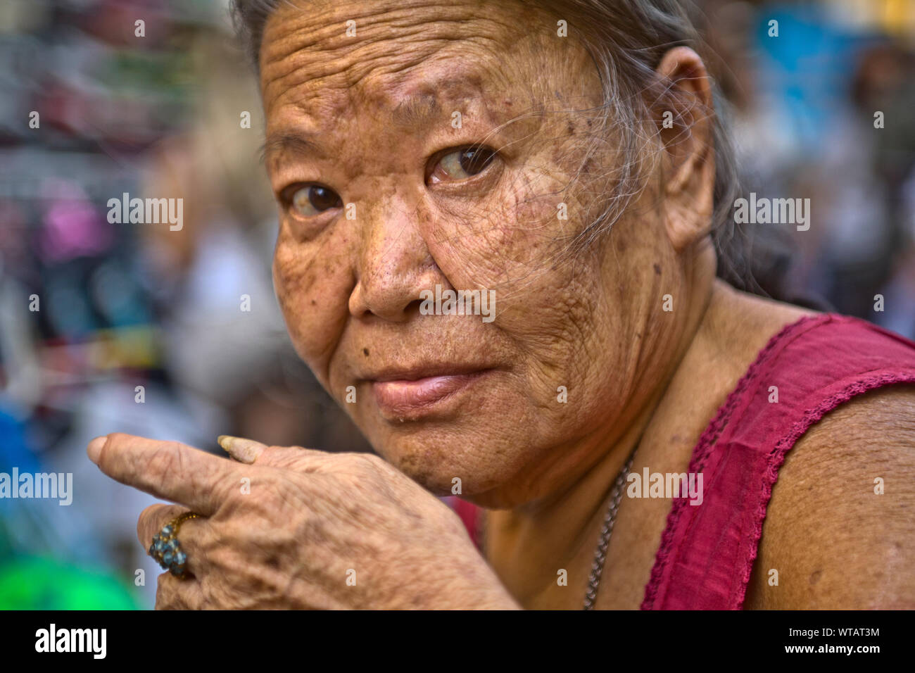 Old woman in the streets of Chinatown Stock Photo