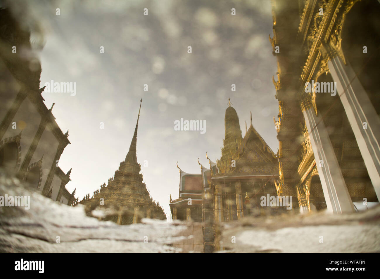 Reflex in a puddle from the Temple of Emerald Buddha Stock Photo