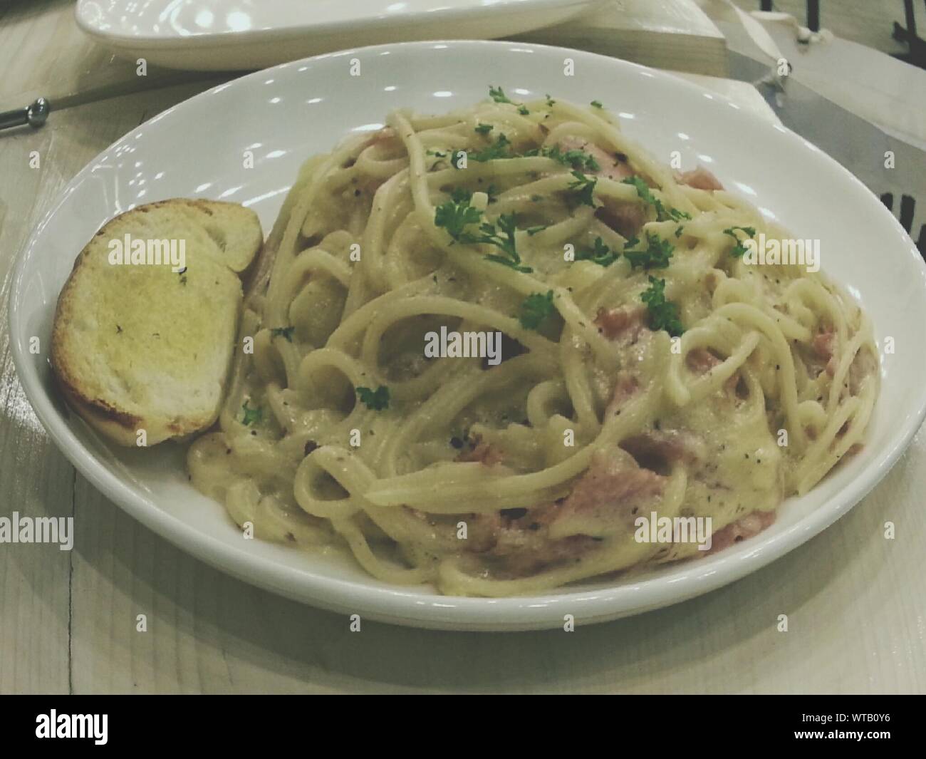 Spaghetti Carbonara With Garlic Bread Stock Photo Alamy