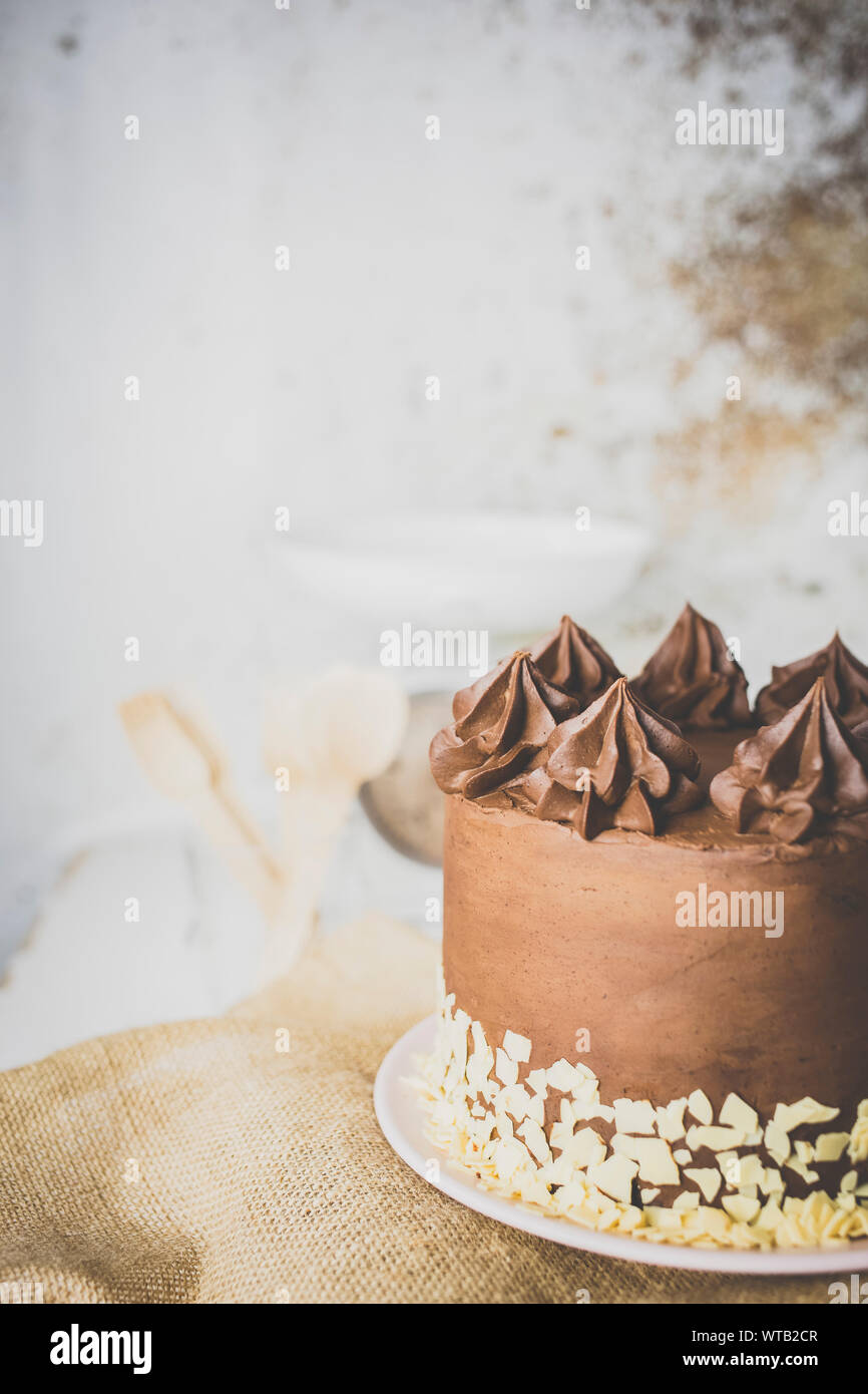 Chocolate cake on the kitchen table ready to eat Stock Photo