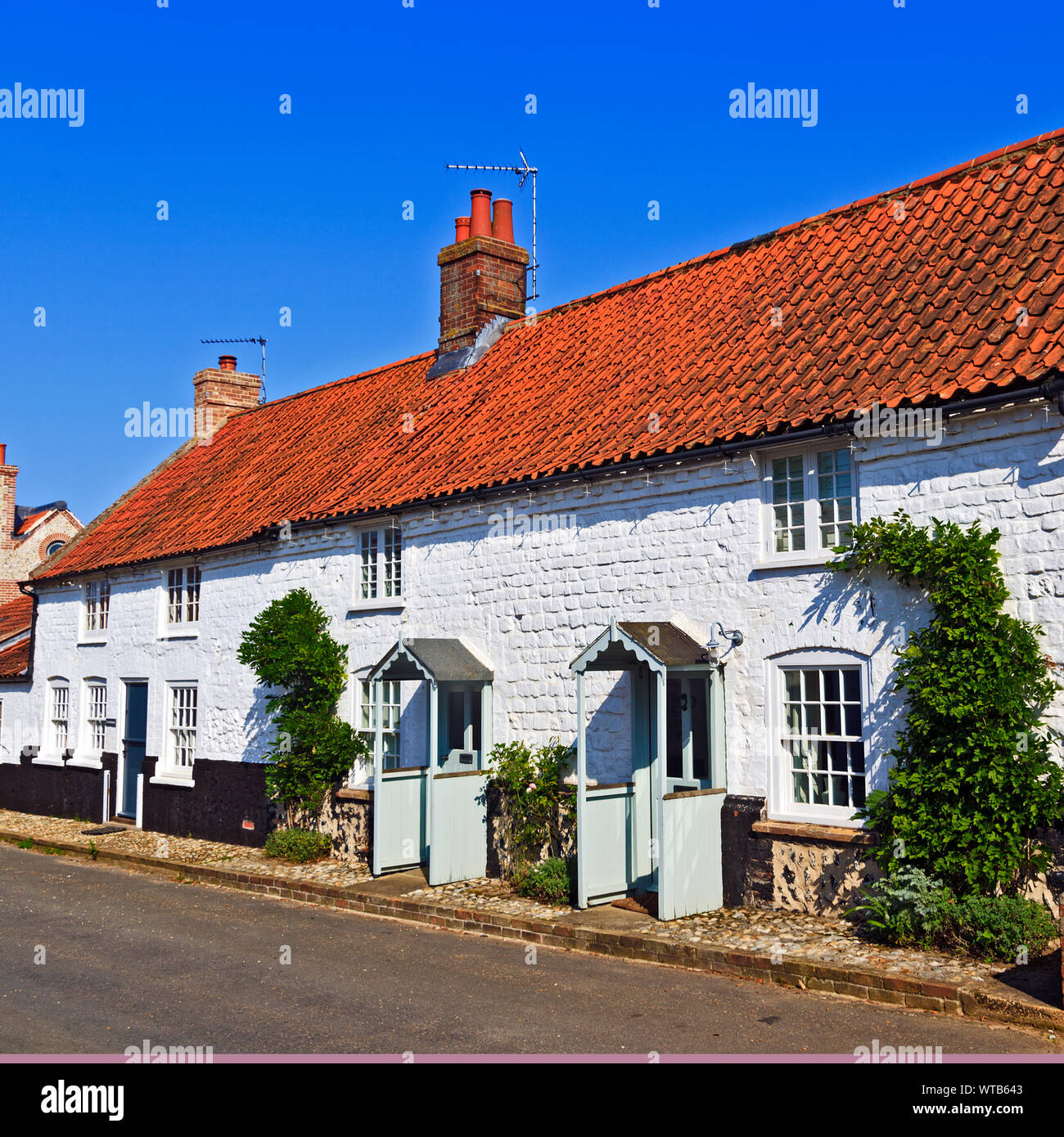 Row of period terraced stone cottages at BurnhamOveryStaithe on the