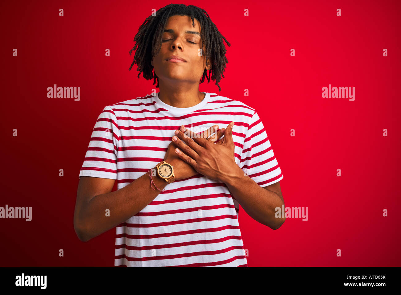 Dreadlocks Chest Young afro man with dreadlocks wearing striped t-shirt standing over ...