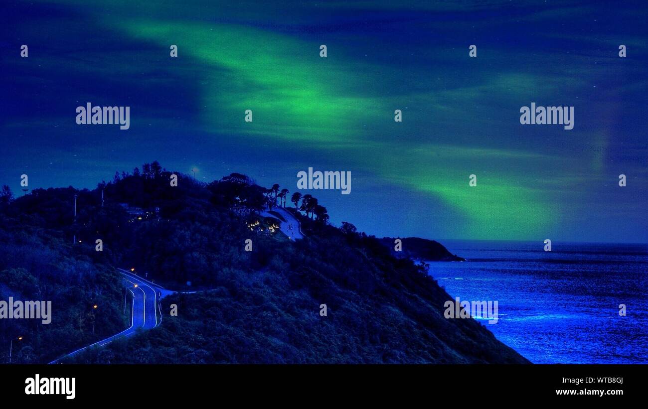 Idyllic Shot Of Aurora Borealis Over Phromthep Cape Stock Photo