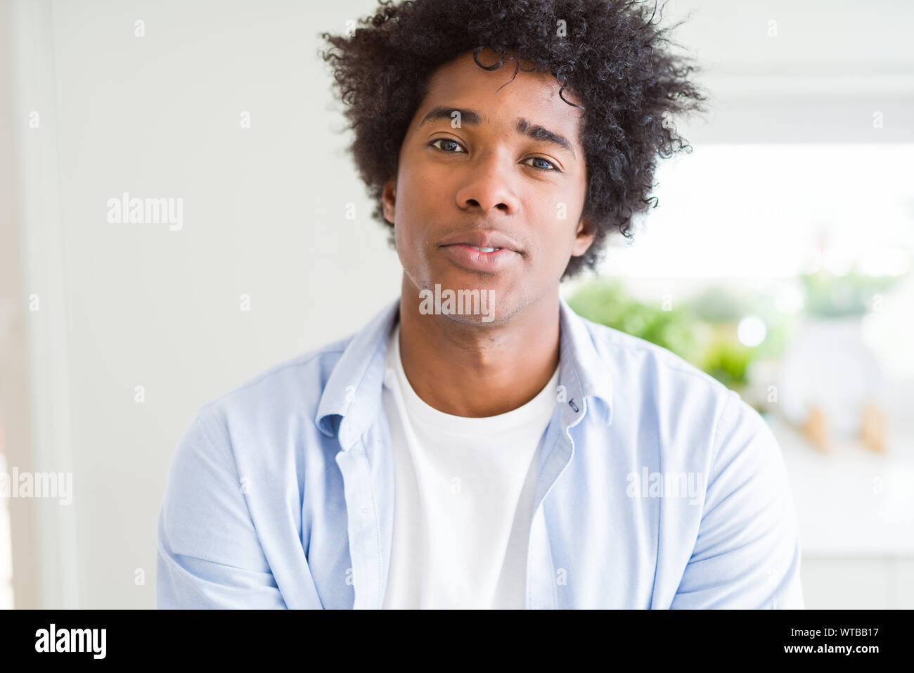 Handsome African American Man With Afro Hair Relaxed With Serious