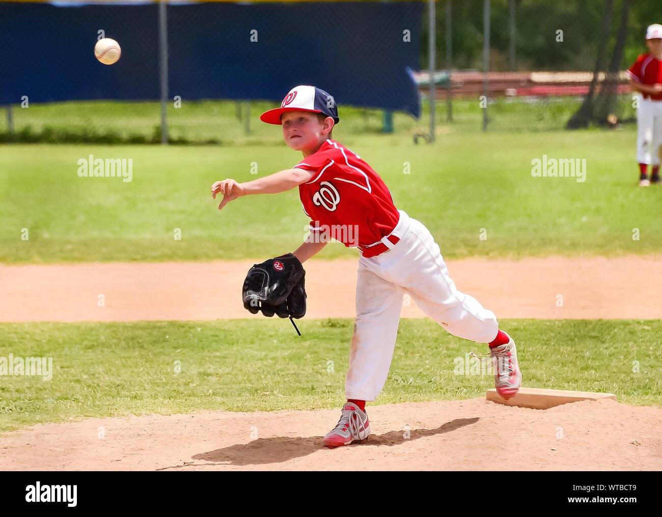 Full Length Of Baseball Pitcher Throwing Ball Stock Photo Alamy