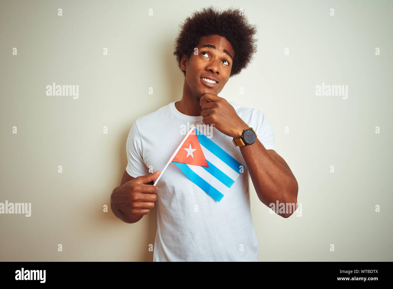 Young african american man holding Cuba Cuban flag standing over ...