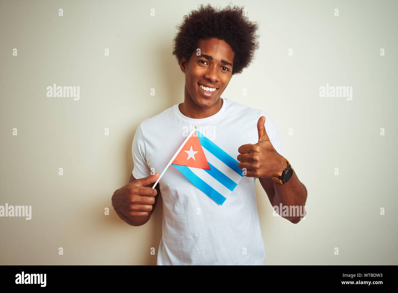 Young african american man holding Cuba Cuban flag standing over ...