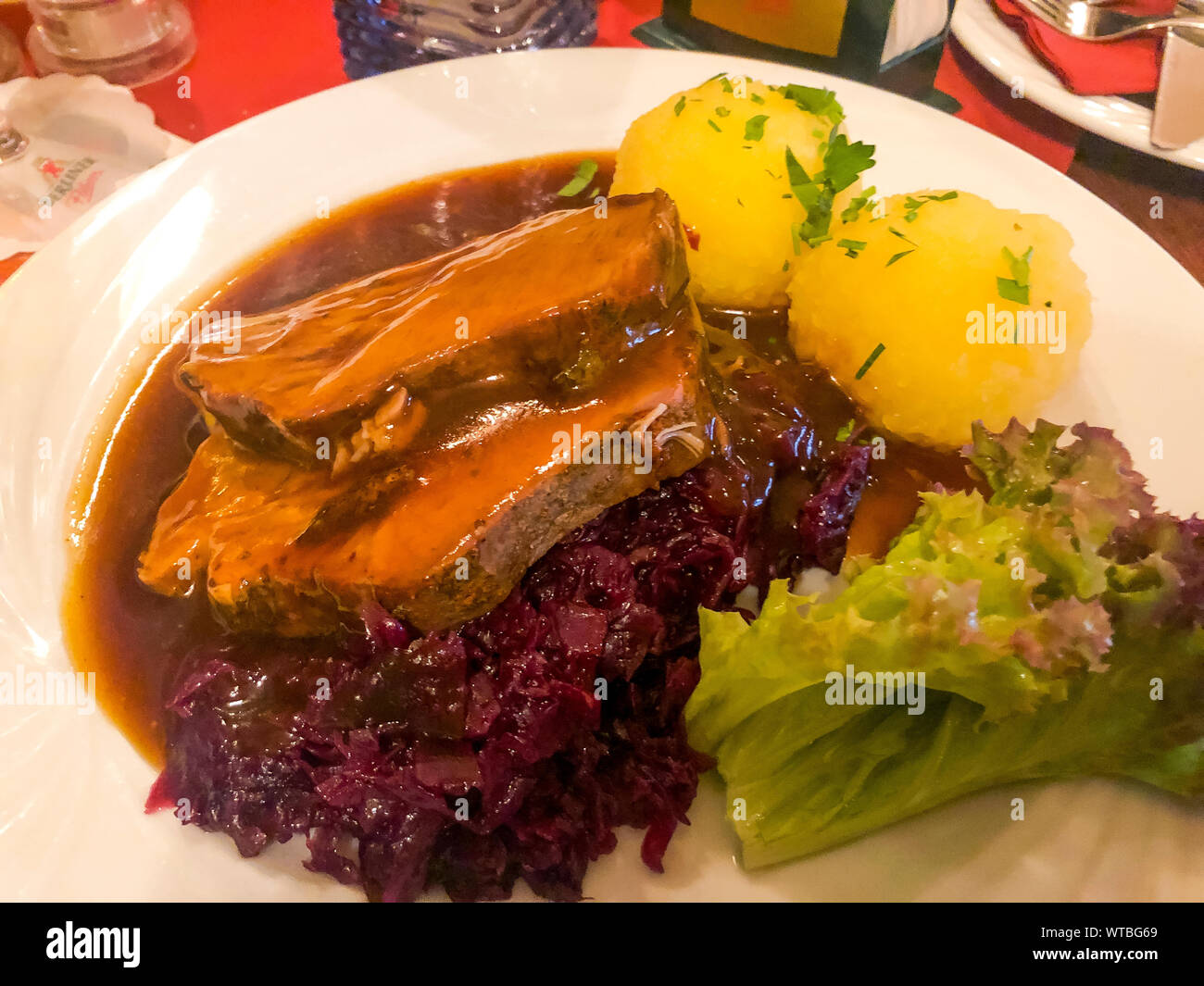 Tasty stewed meat, red cabbage and potato dumplings. Photo Studio Stock Photo