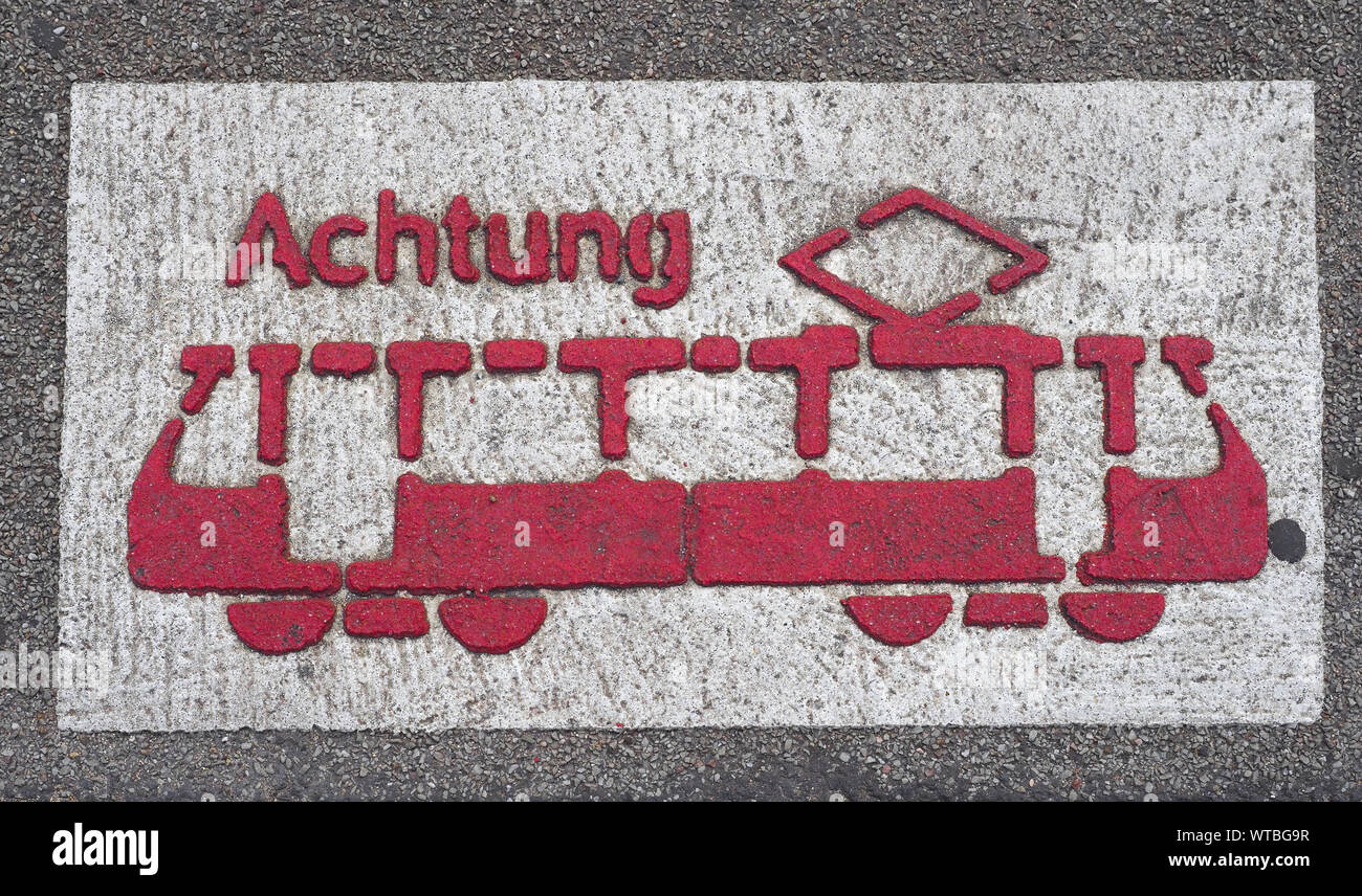 Achtung (meaning warning) tram sign in Koeln, Germany Stock Photo