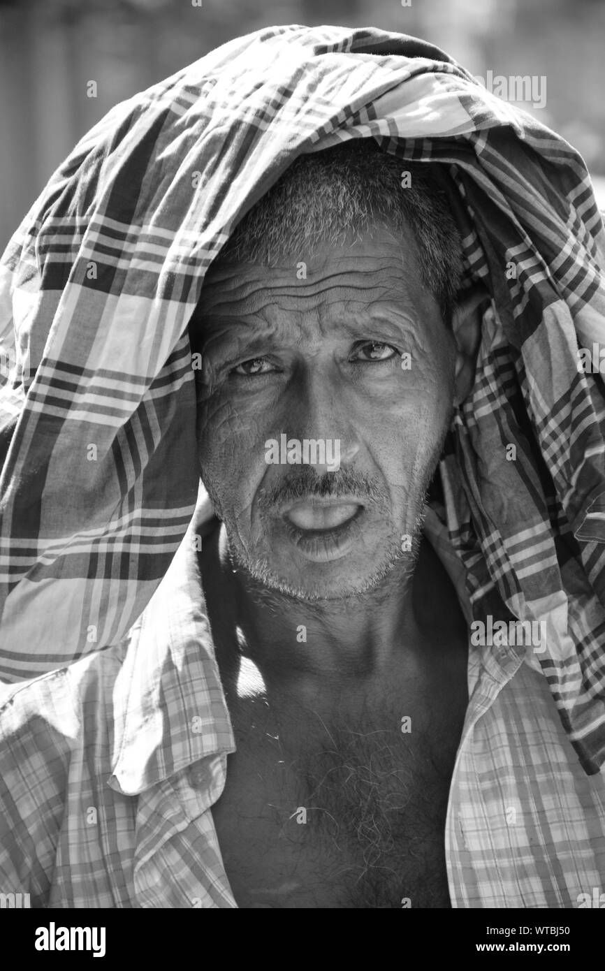 Rickshaw Hawker tired on the road. Stock Photo