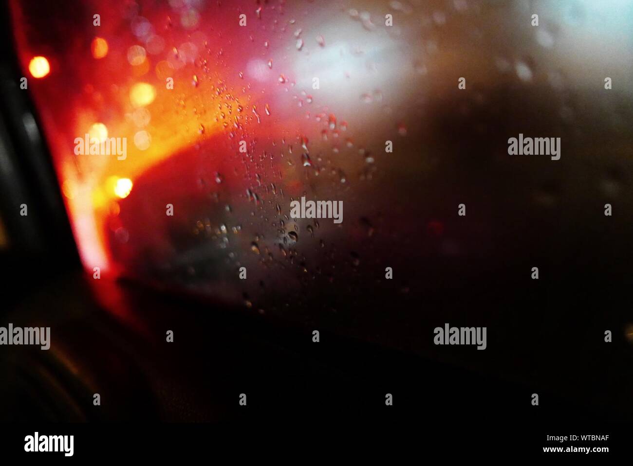 Close-up Of Wet Car Window During Rainy Season Stock Photo