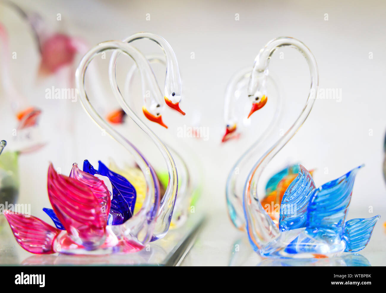 Beautiful crystal swans, Close up with selective focus and neutral soft background, Soft focus. Stock Photo