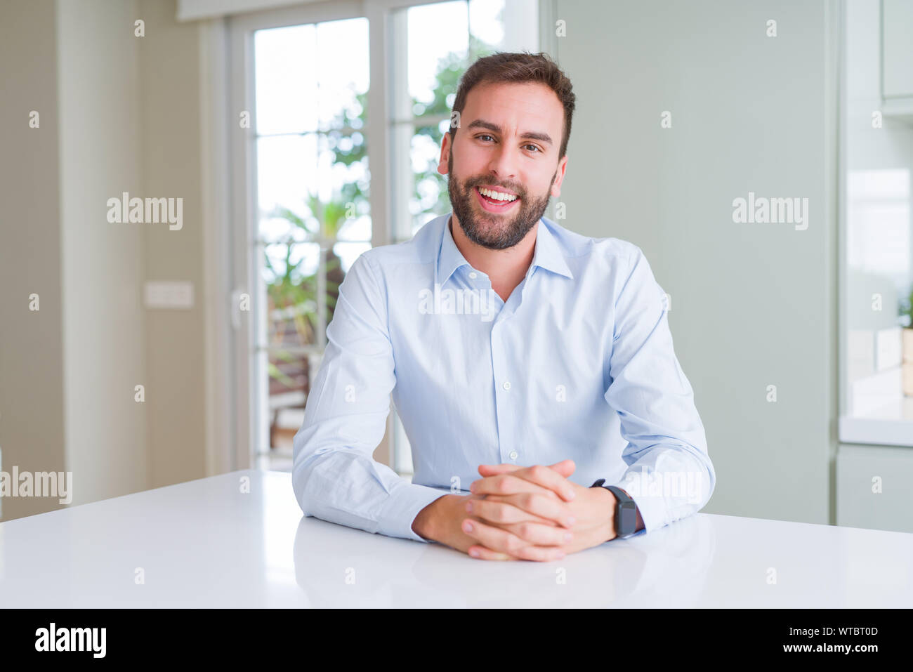 Handsome business man smiling positive at the camera Stock Photo - Alamy