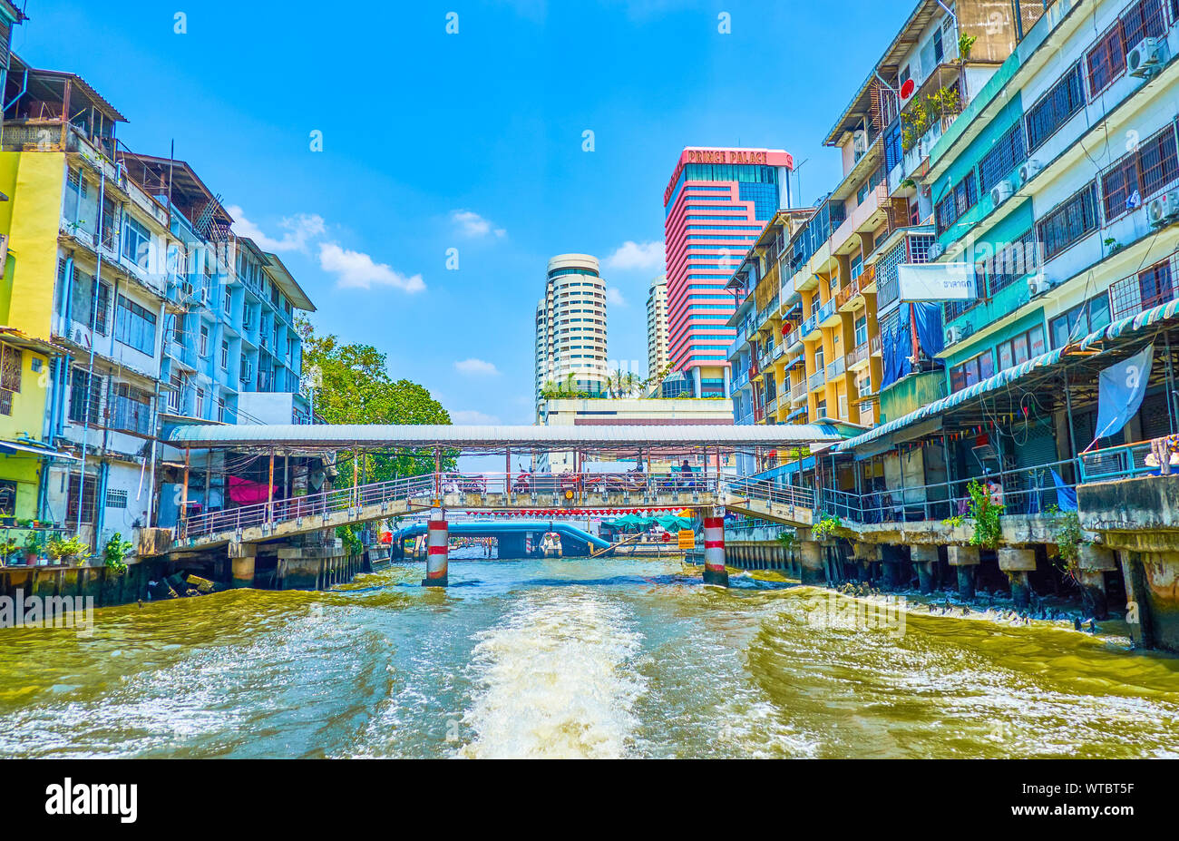 BANGKOK, THAILAND - APRIL 24, 2019: The Saensaep khlong leads through modern district of the city with residential houses,  numerous bridges and high Stock Photo