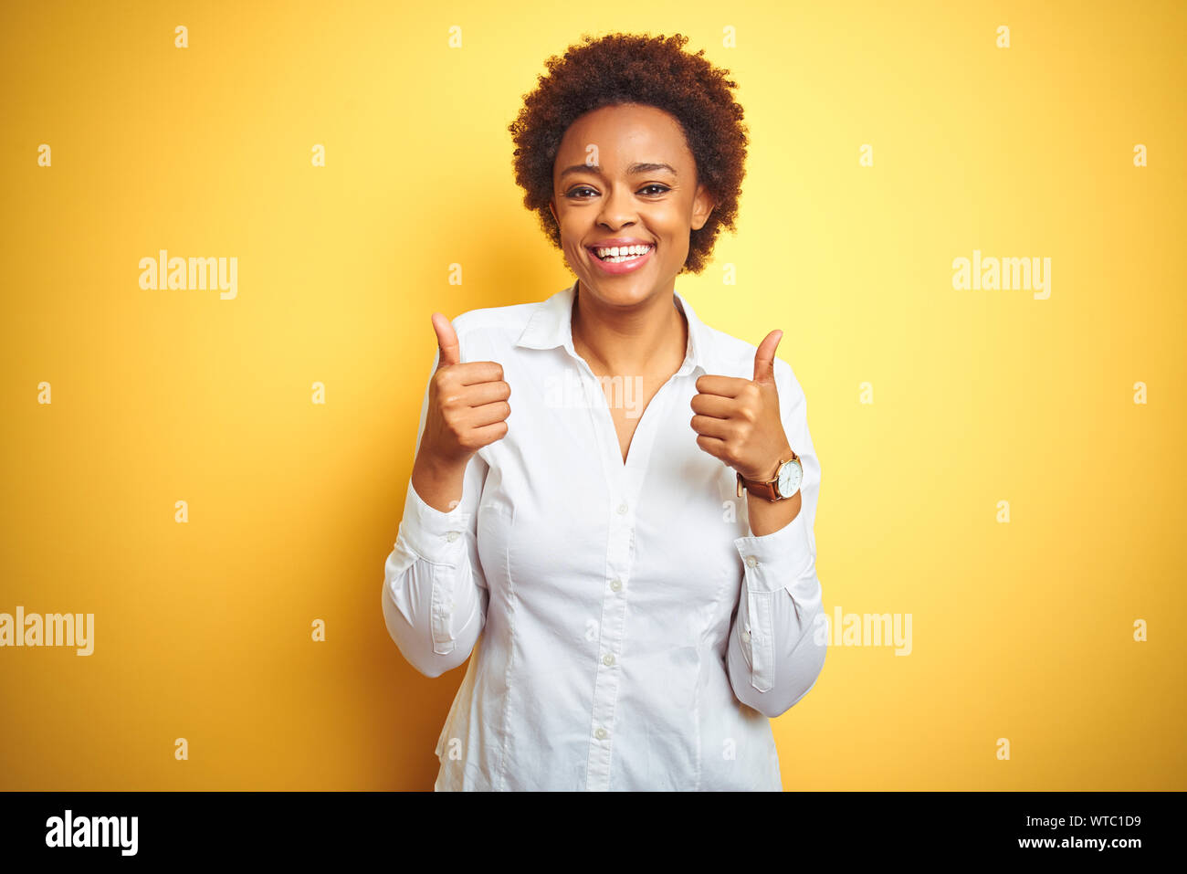 African american business woman over isolated yellow background success ...