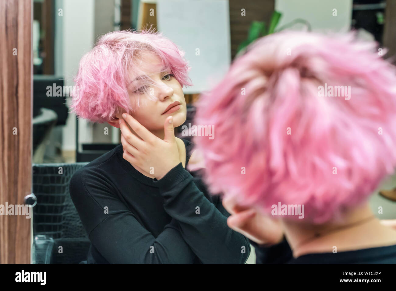 Beautiful Hairstyle Of Young Woman Looking In The Mirror