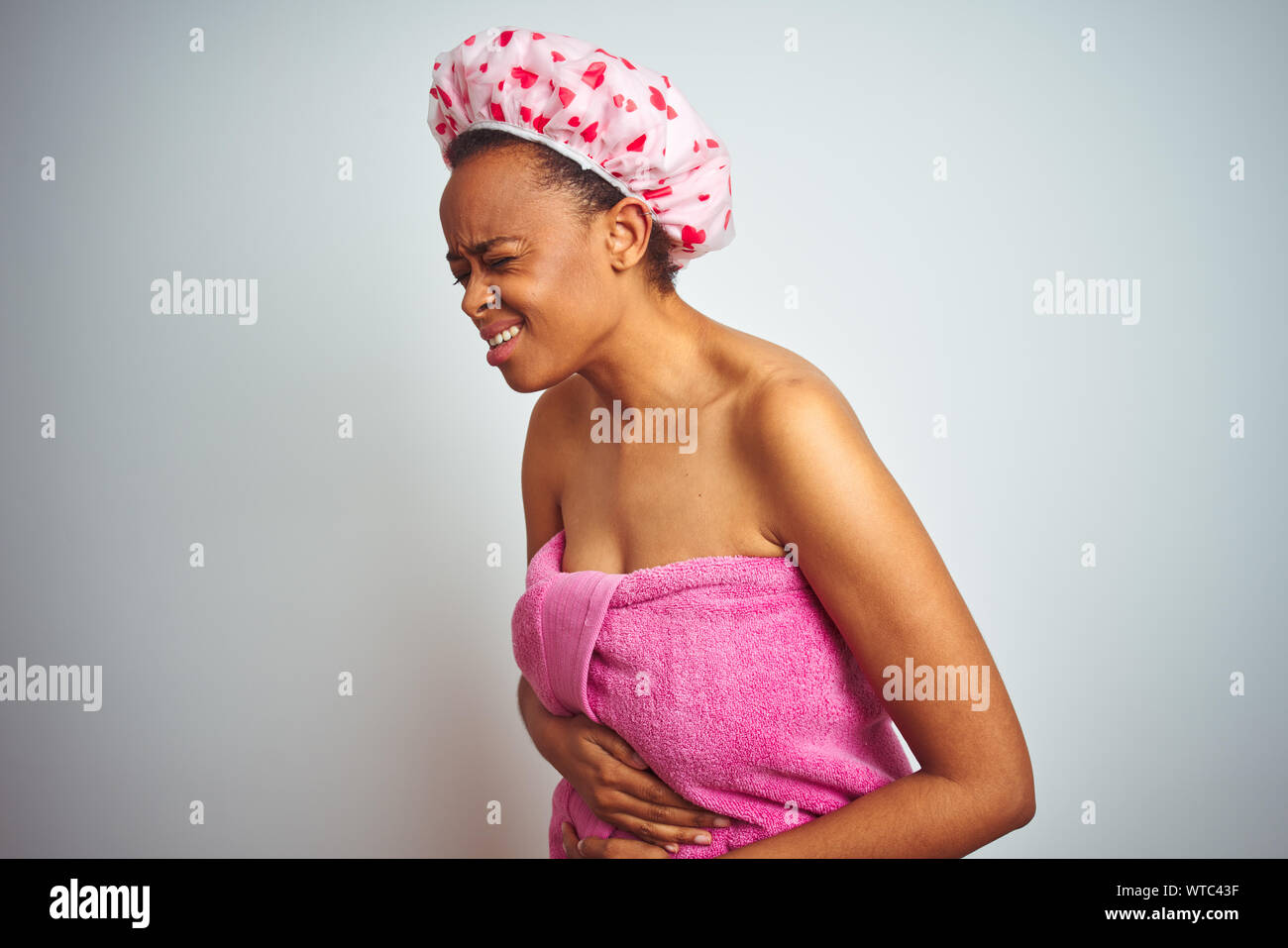 African american woman wearing pink shower towel after bath over