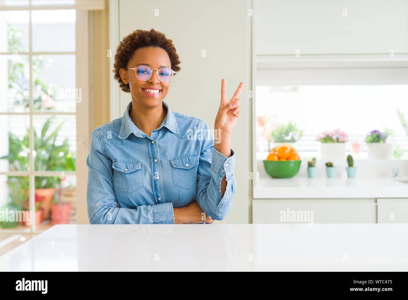 Young beautiful african american woman wearing glasses smiling with ...