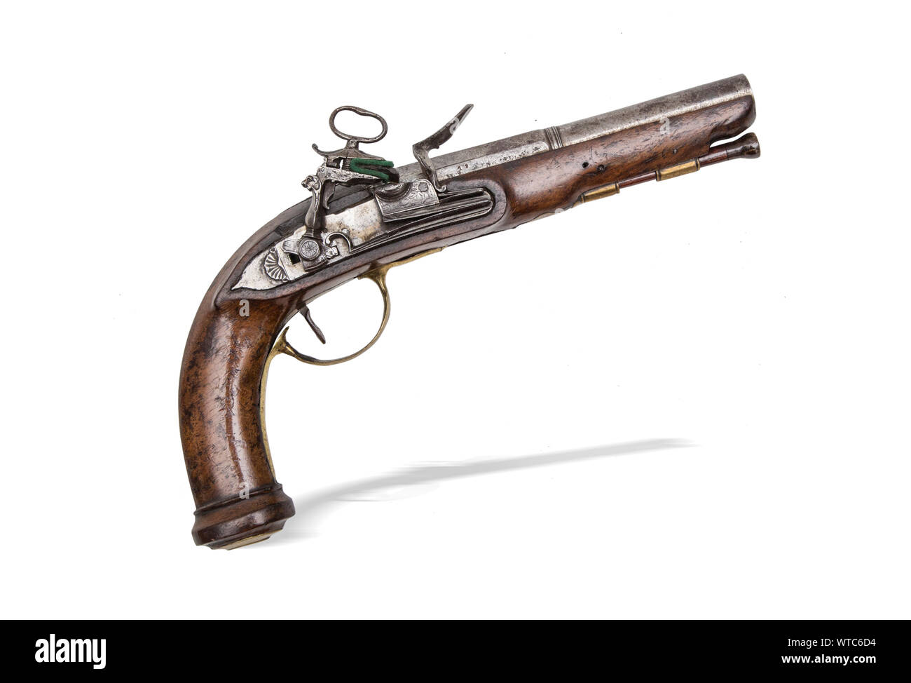 Italian miquilet pistol of the 18th century. With 16 mm caliber round barrel with fine chiseled miquilet lock, brass mounts and trigger guard. Stock Photo