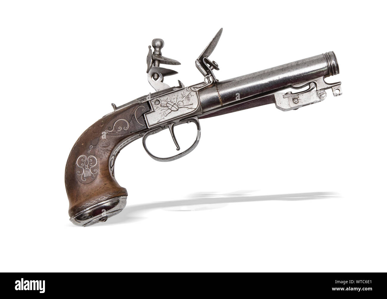 European flintlock pistol of the 19th century, approximately .55 caliber, with a folding bayonet, safety, wire inlay wooden grips, and a 4’’ round bar Stock Photo