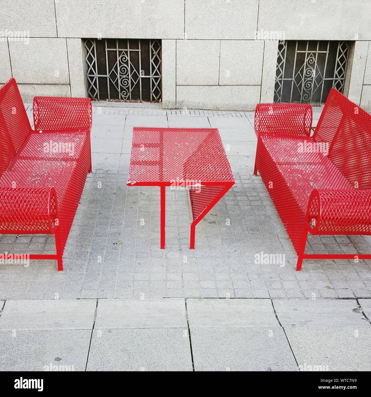 Red Benches And Table On Sidewalk By Building Stock Photo Alamy