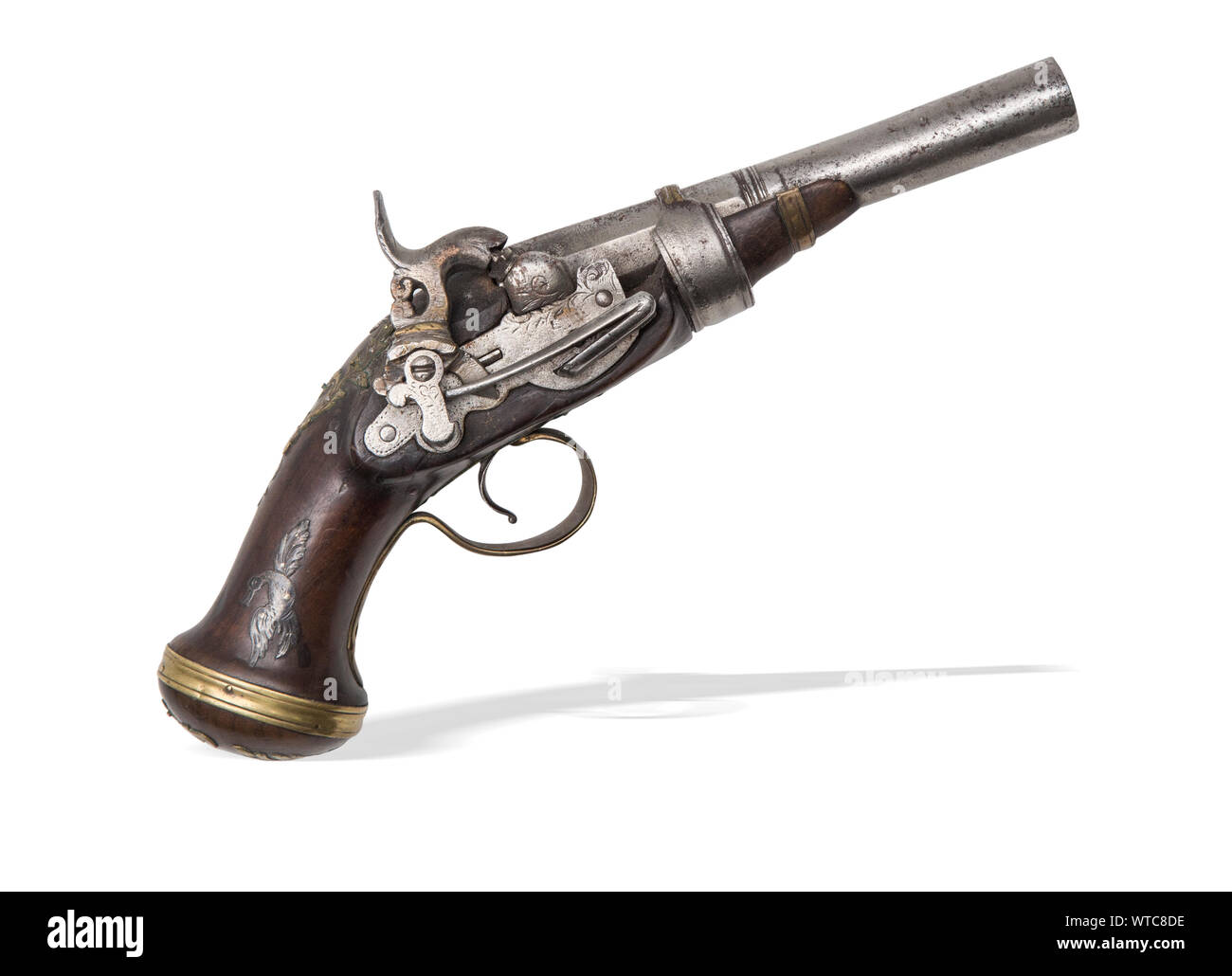Percussion pistol of the 19th century. A conversion from 18th century flintlock pistol. Wooden stock decorated with silver and brass inlays. Stock Photo