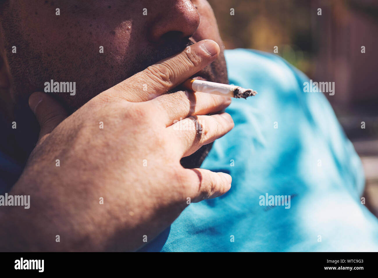 fat guy smoking cigarette Fat man smoking cigarette outdoor close up Stock Photo