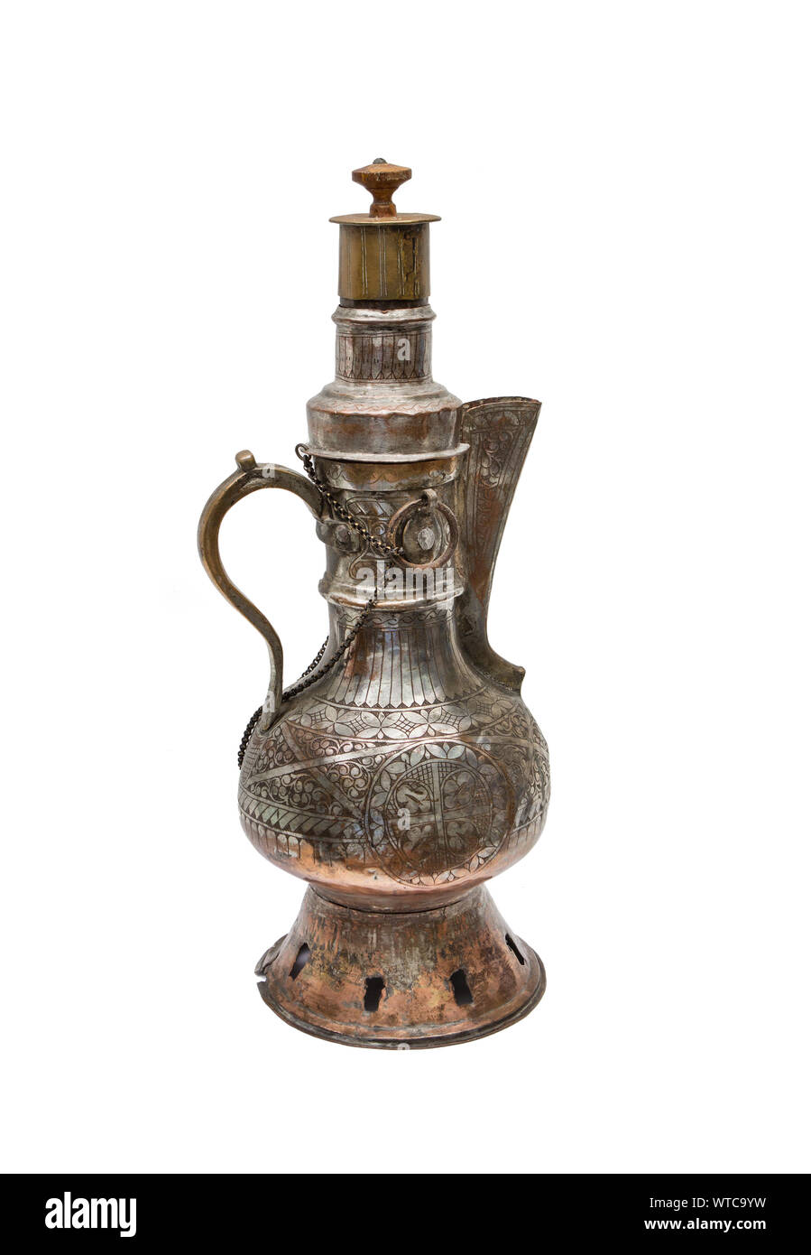 Central Asian kumgan of the 19th century made of hammered brass decorated with elaborate engraving. Stock Photo