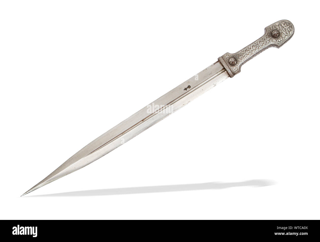 Caucasian dagger with blade decorated with etching. Thick silver mounts with engraving finished with niello. Stock Photo