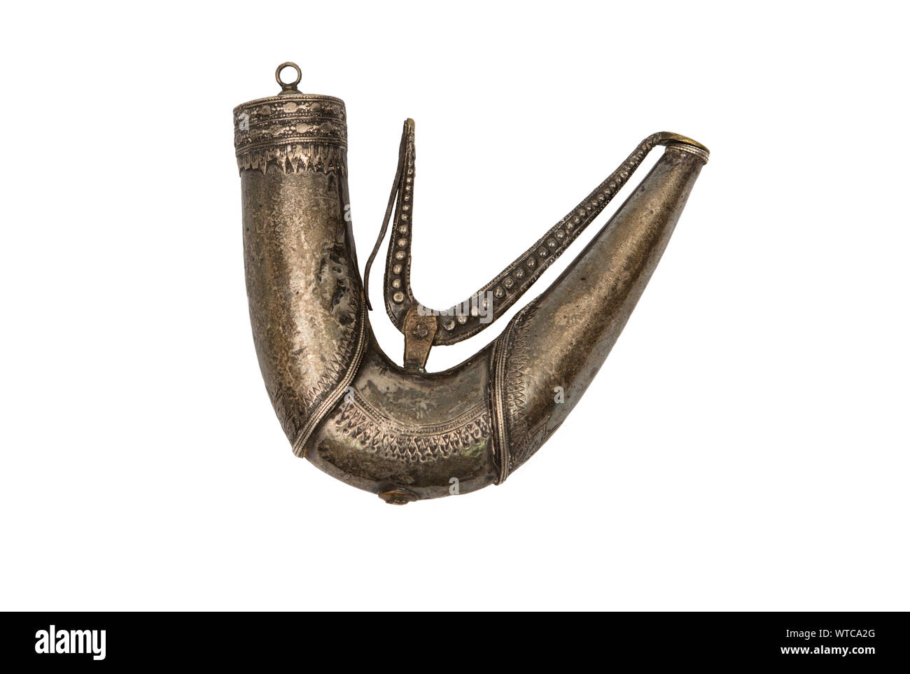 Mid 19th century silver gunpowder flask or charger from Southern Arabia. Finely chiseled surface, with moving lever for the mouth opening. Stock Photo