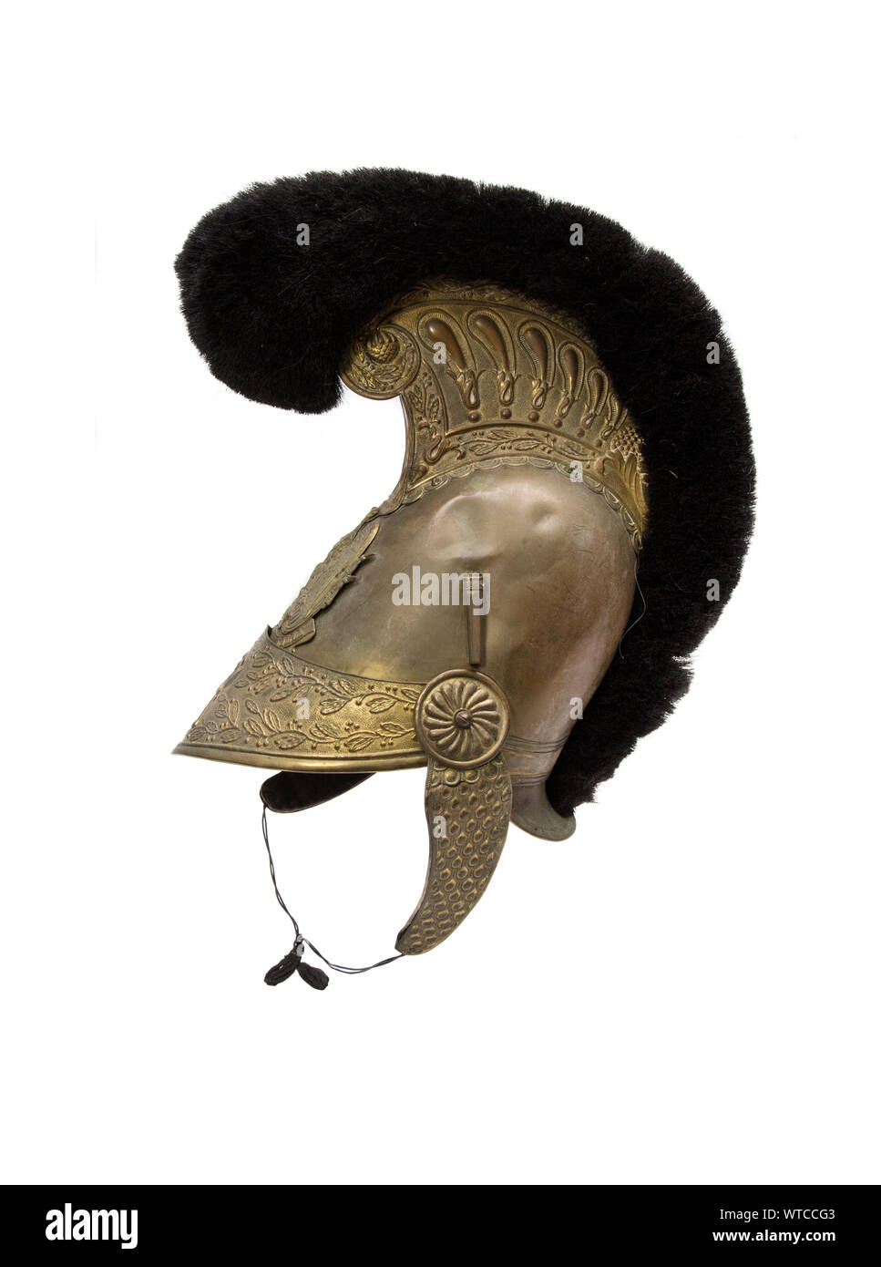 French firefghter helmet, model 1816. Entirely brass with neck brace surmounted by a crest. Stock Photo