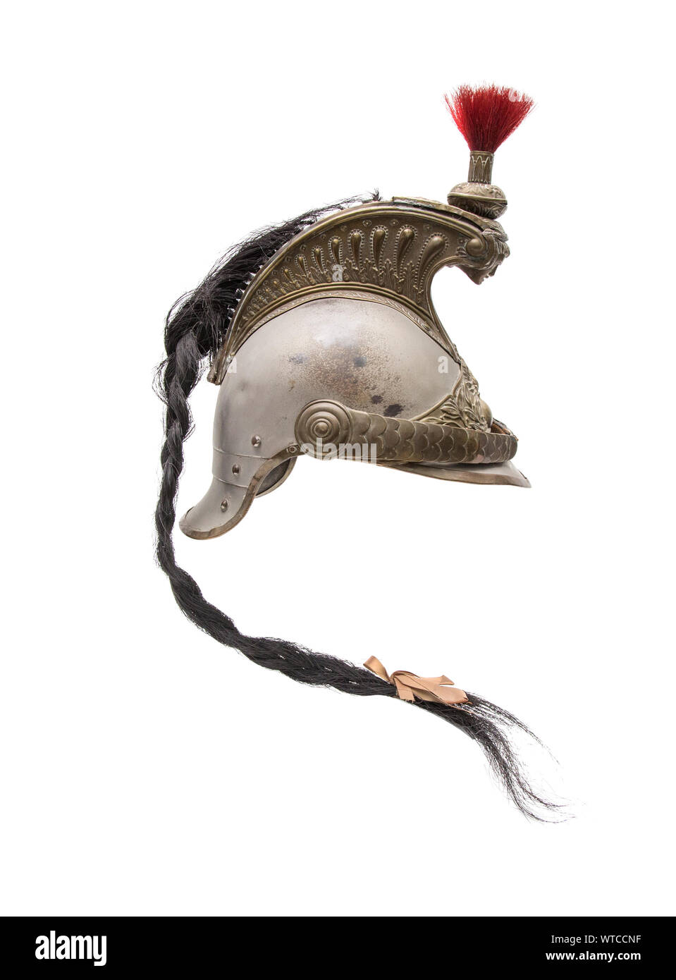 French Cuirassier Helmet of the 19th century. The helmet has a steel skull with brass edging, fittings, and a crest with repoussé decoration, the head Stock Photo