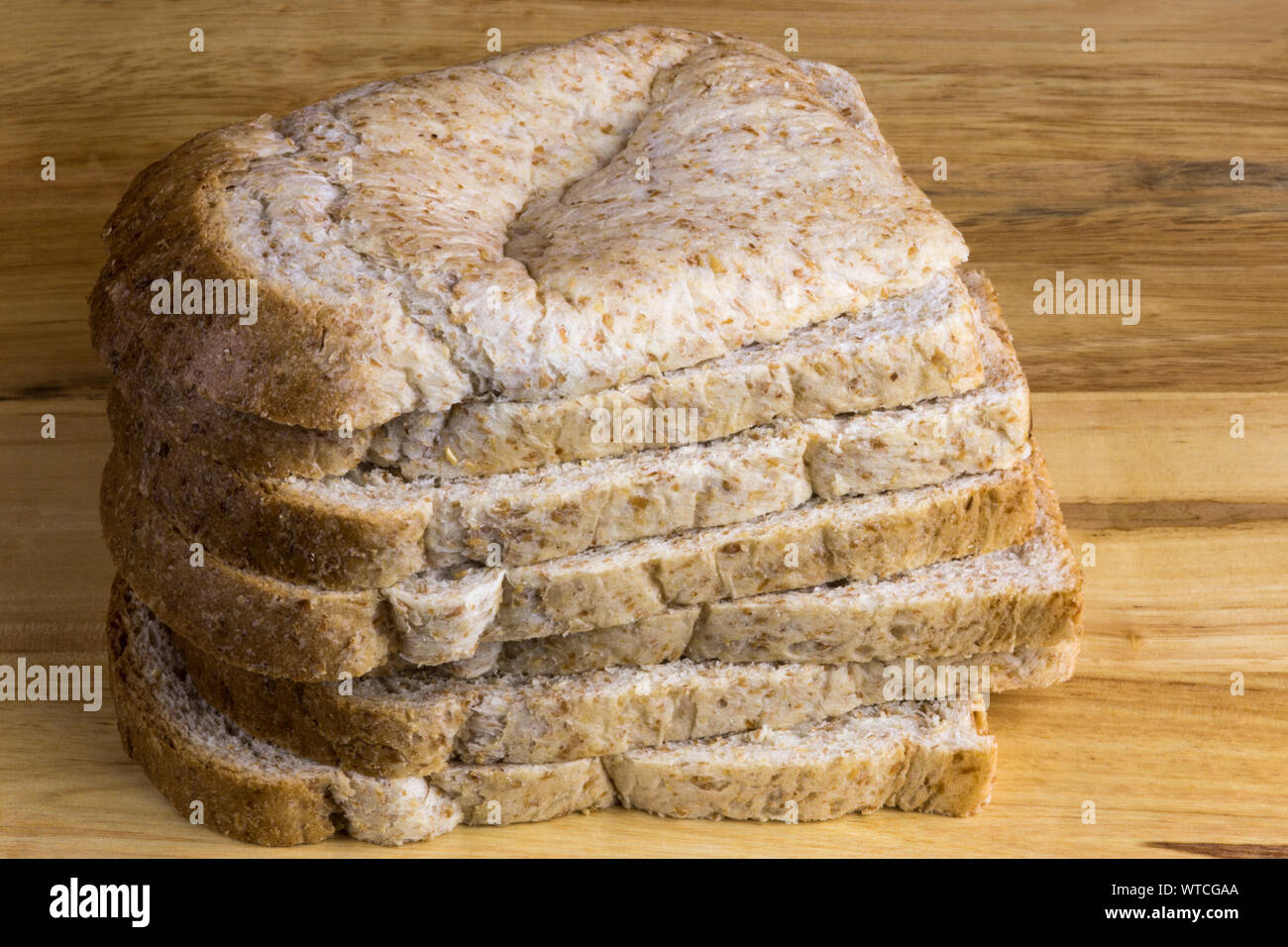 Stack of wholemeal bread slices on a wooden bread board Stock Photo - Alamy