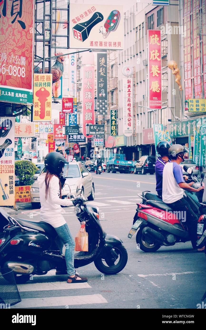 People Riding Scooters In City Stock Photo Alamy