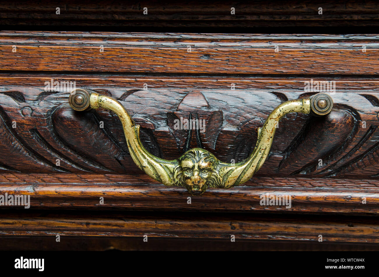 Part of old  kitchen sideboard as example of beautiful wood engraving as background. Stock Photo