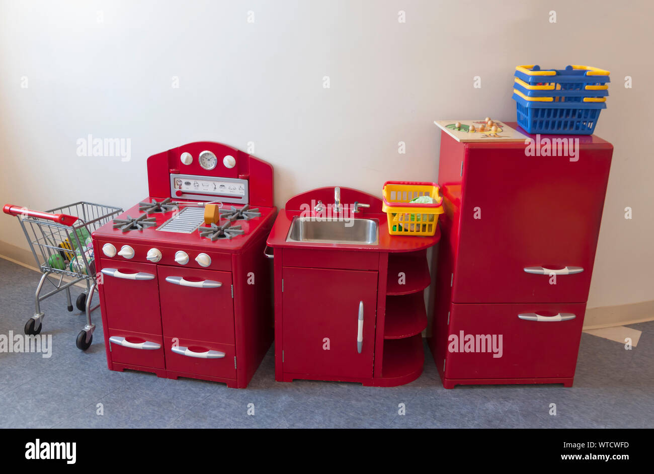 Shopping cart, stove, oven, sink, refrigerator toys for children. Stock Photo
