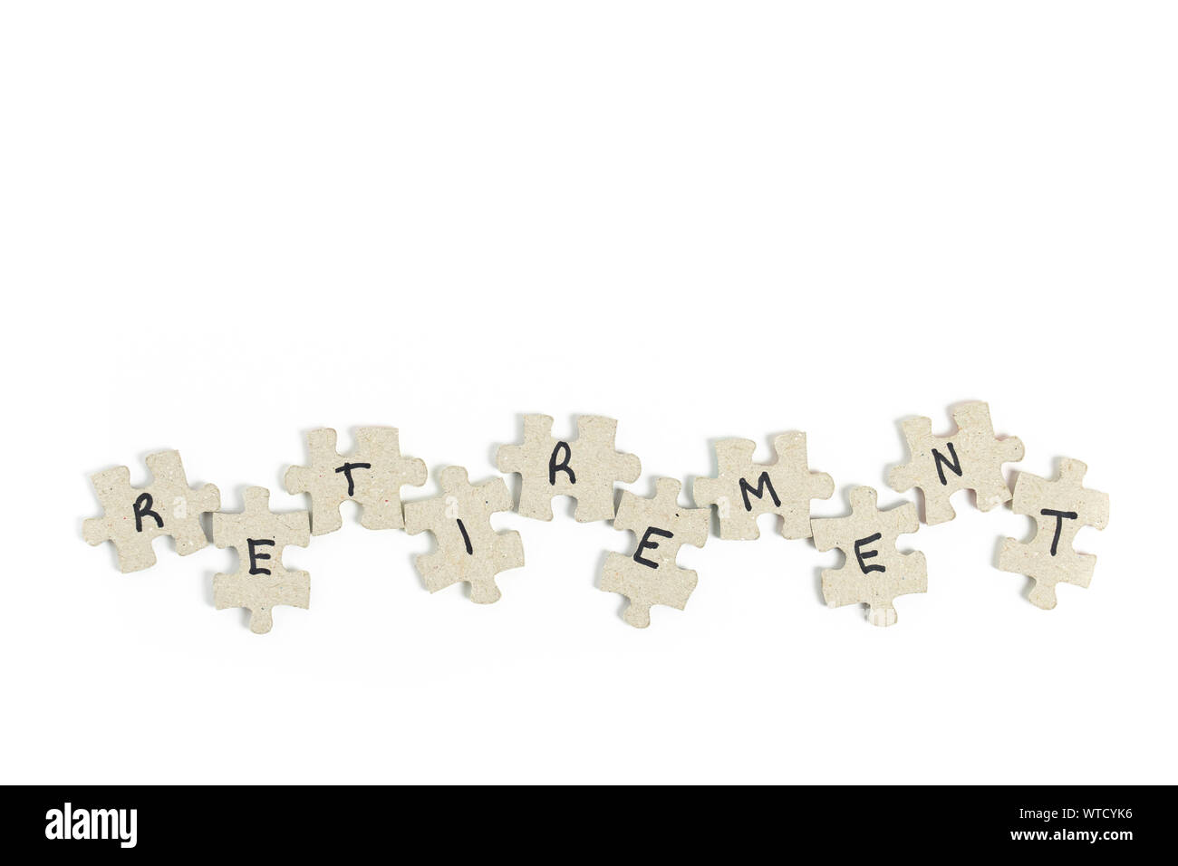 jigsaw puzzle pieces with letters written on them spelling out retirement isolated on white for the concept of the difficulty of planning and funding Stock Photo