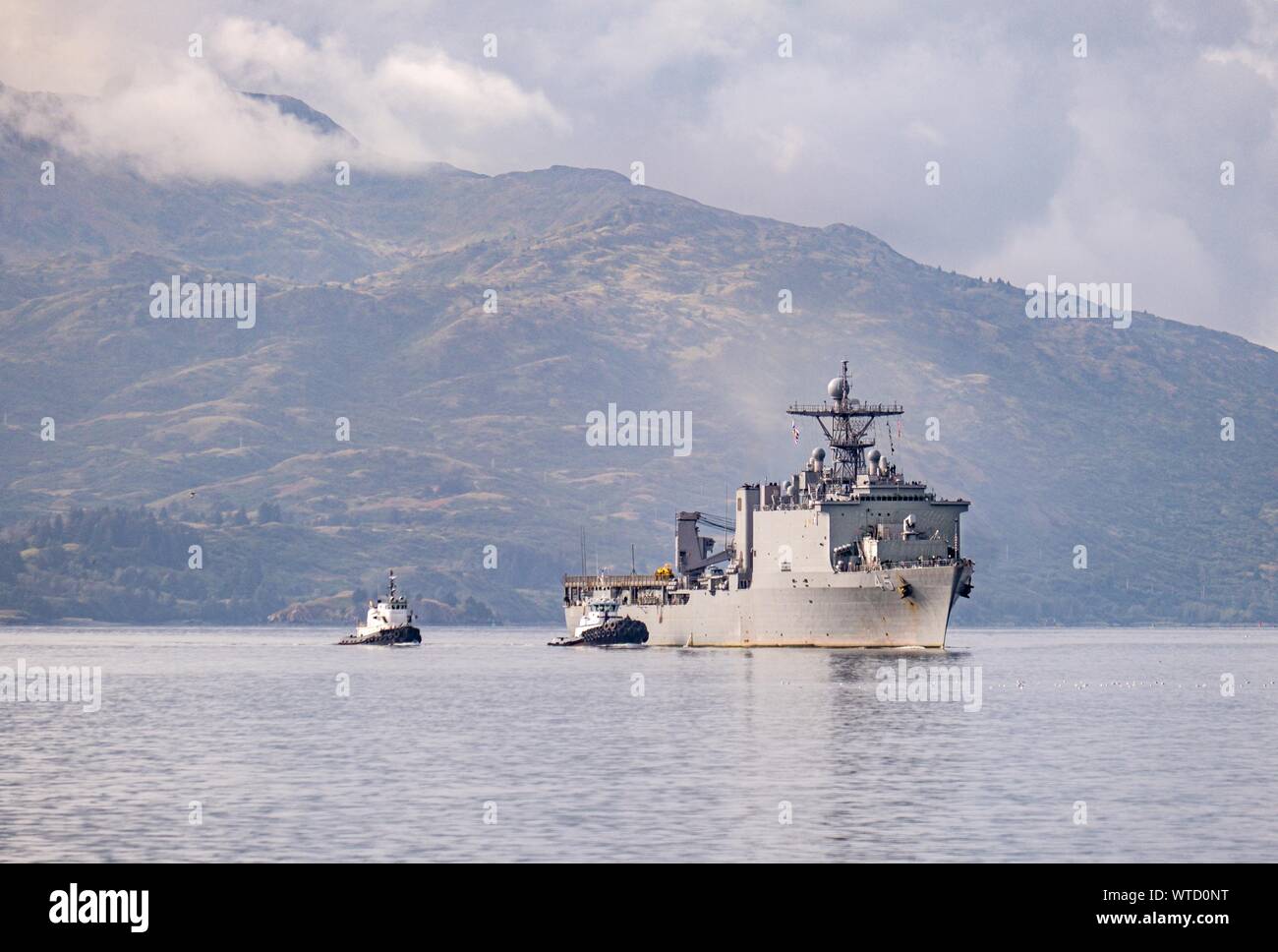 USS Comstock (LSD 45) pulls into Kodiak, Alaska for a port visit during the Arctic Expeditionary Capabilities Exercise (AECE) 2019.  Approximately 3,000 U.S. Navy and Marine Corps personnel participate in AECE 2019, a joint training exercise that tests expeditionary logistical capabilities in the Arctic region and prepares joint forces to respond to crises across the Indo-Pacific. (Photo by Senior Chief Petty Officer Brandon Raile) Stock Photo