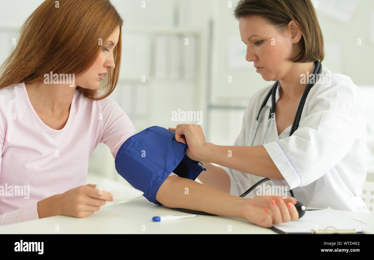 Measuring Caring Woman in hospital with caring doctor measuring pressure Stock Photo - Alamy