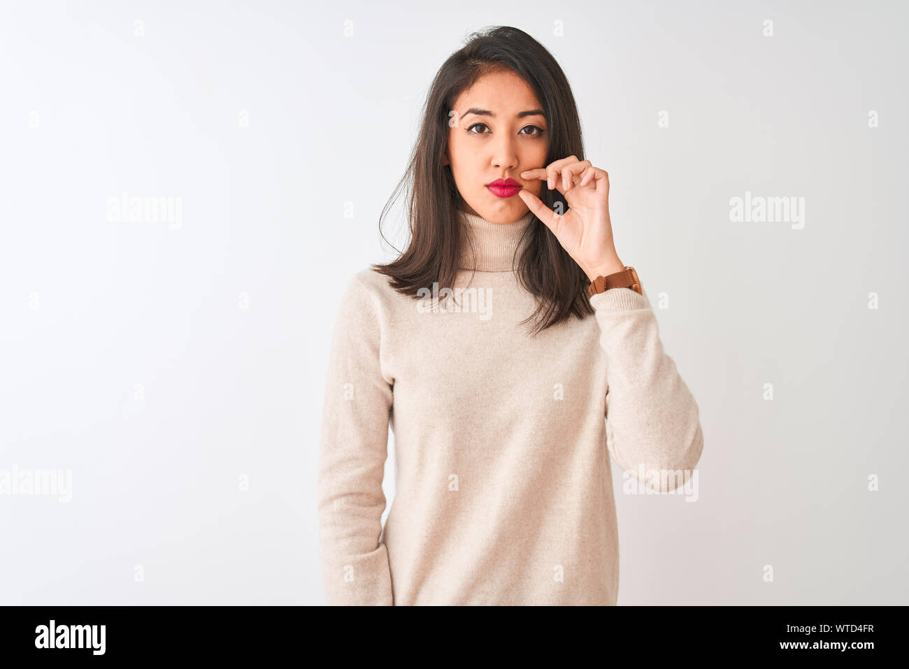 Beautiful chinese woman wearing turtleneck sweater standing over