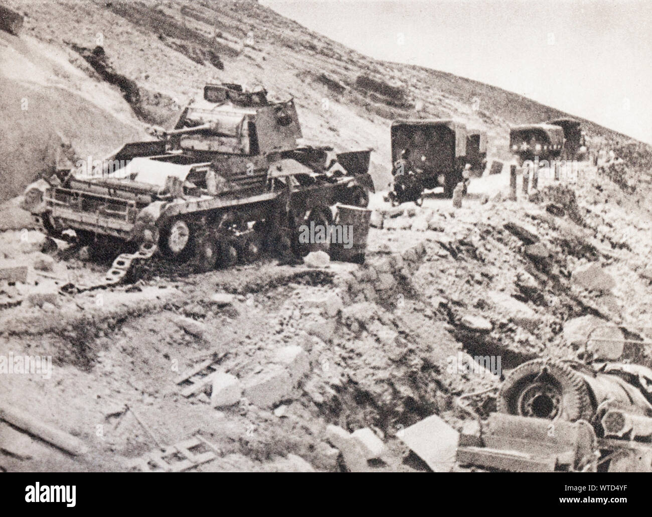 WWII period. Fighting in Cyrenaica. The successive advances and retreats of the opponents let the roads strewn with destroyed material. Stock Photo