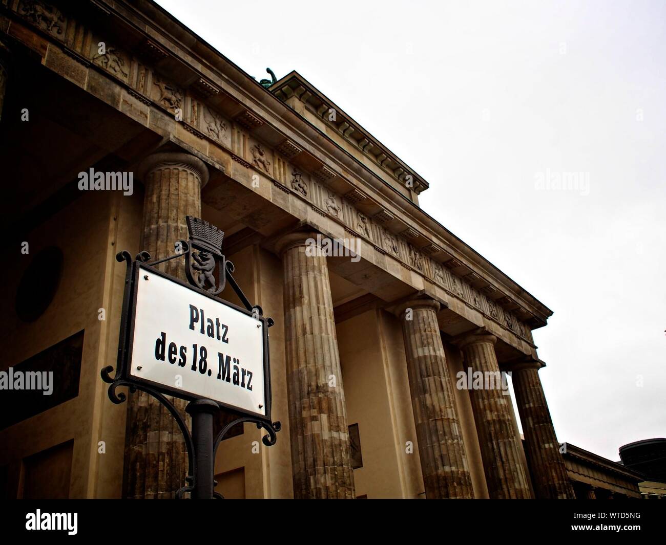 Low Angle View Of Platz Des 18 Marz Sign At Brandenburg Gate Against Clear Sky Stock Photo