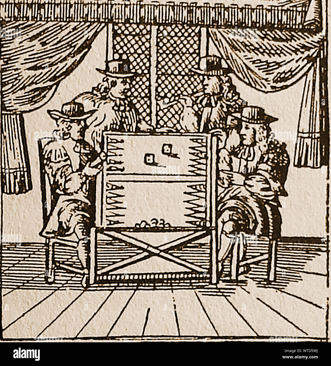 17th century games and pastimes  in Britain - A woodcut from the time showing four men playing backgammon. One is smoking a long pipe Stock Photo