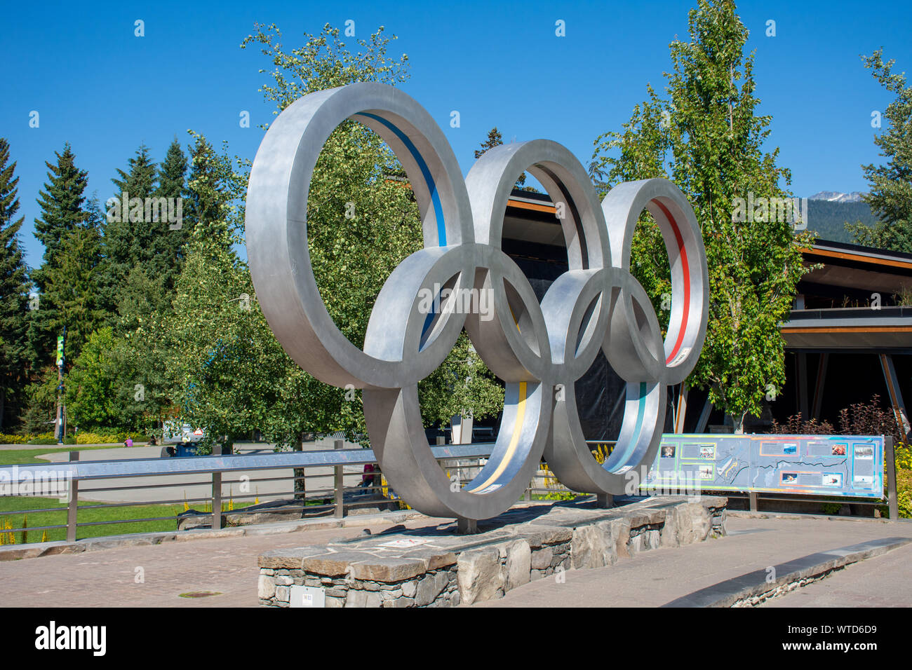 'Whistler, British Columbia/Canada - 08/07/2019: Whistler village Vancouver 2010 Olympics rings in the Olympic village in the summer blue sky.' Stock Photo