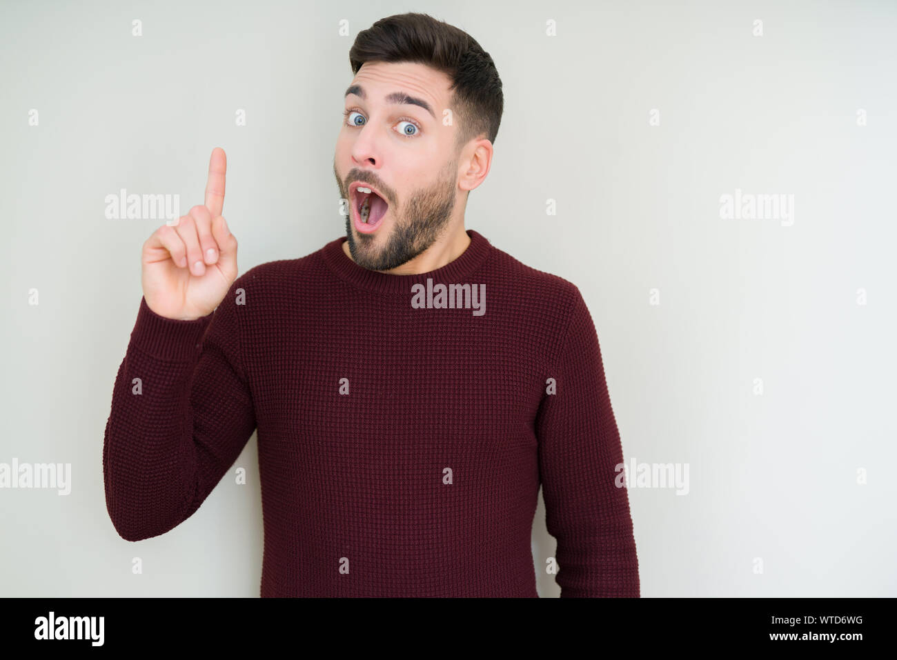 Young handsome man wearing a sweater over isolated background pointing ...