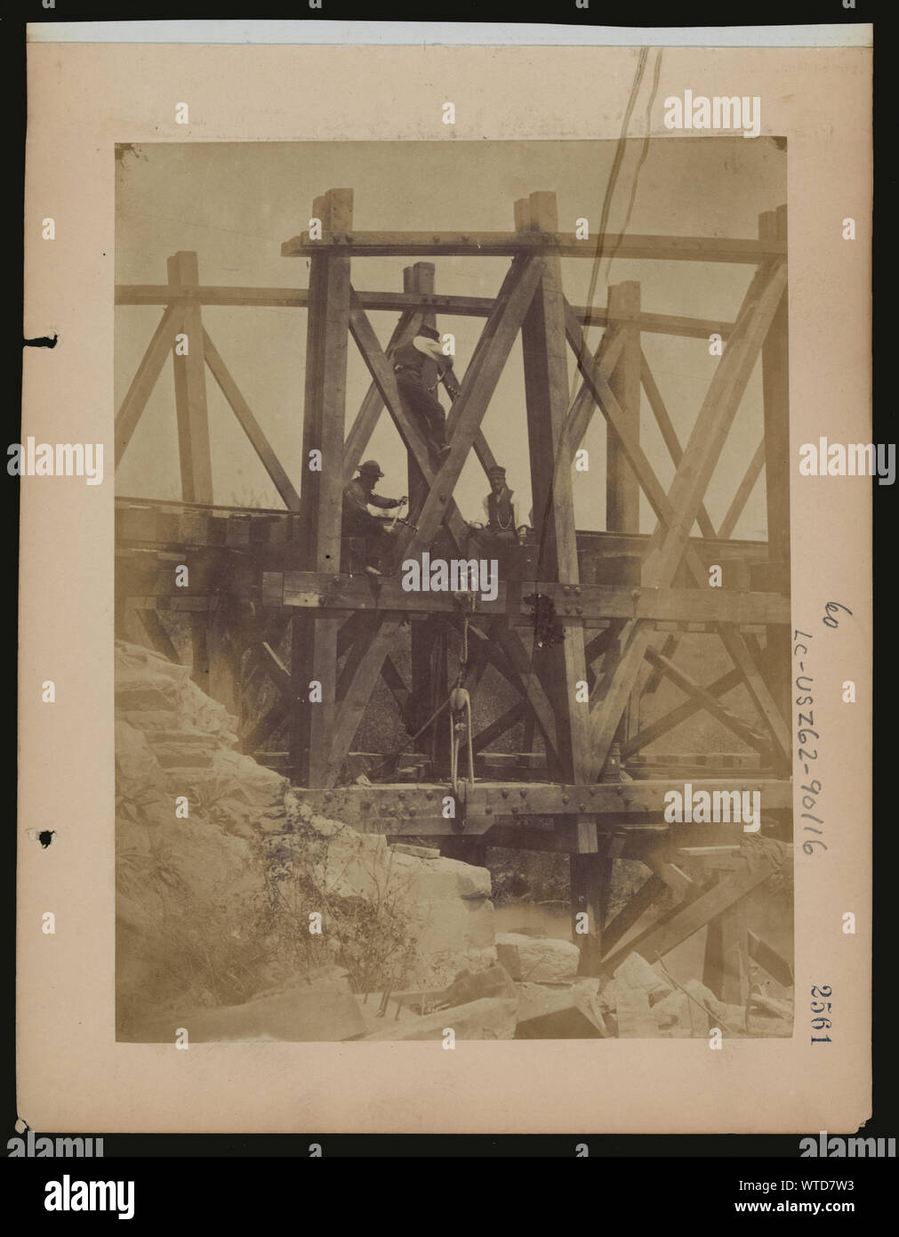 Military railroad operations in northern Virginia: two men boring holes in bridge trestles and man with Haupt's Torpedo Stock Photo