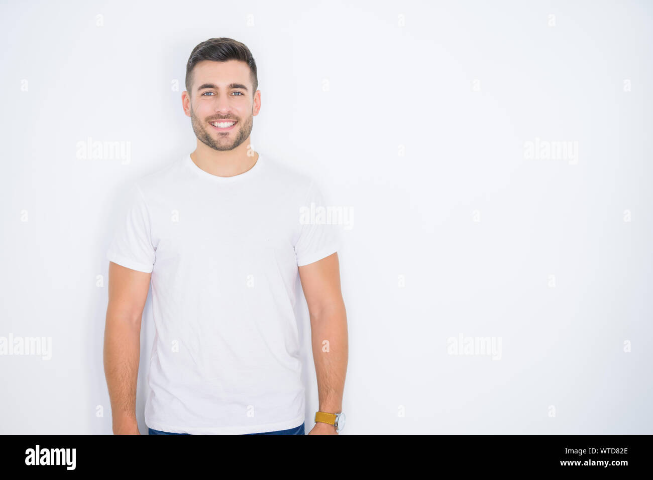 Young handsome man smiling happy wearing casual white t-shirt over ...