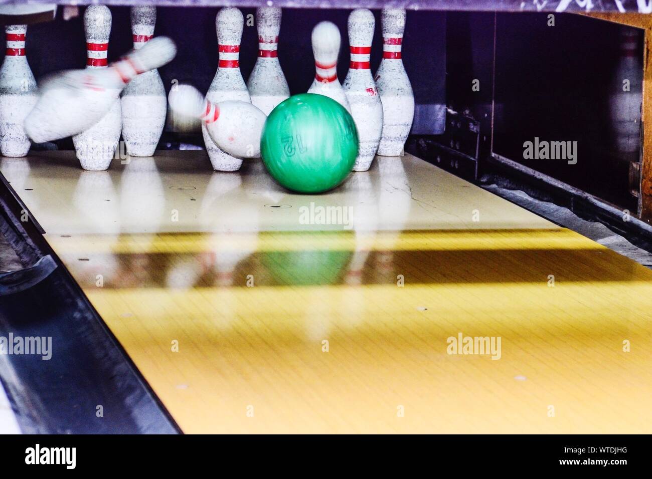 Bowling Ball Knocking Over Skittles Stock Photo
